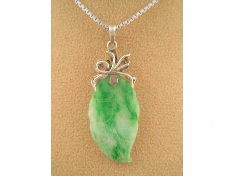 An oriental jade leaf pendant on white metal chain