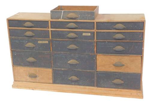 A Victorian pine tool chest, of fifteen graduated drawers, with cast iron handles, raised on a plinth base, 71cm H, 125cm W, 30cm D.