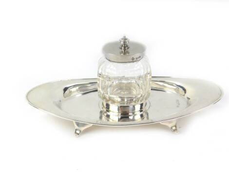 A late Victorian silver inkstand, with silver topped faceted crystal oval well, silver elliptical base on four scroll feet, marked JAS.D Werryhouse Liverpool No.73132 to base. Maker Horace Woodward & Co Ltd. London 1899. 20cm W, 4oz of weighable silver.