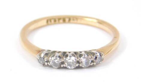 An 18ct gold platinum and diamond five stone ring, approximately 0.15cts, size M, 2.0g.