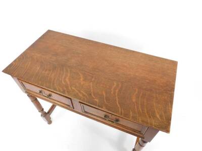 An early 20thC oak side table, 17thC style, with two frieze drawers, raised on turned legs, united by an H frame stretcher, 75cm H, 91cm W, 45cm D. - 2