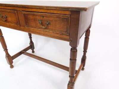 An early 20thC oak side table, 17thC style, with two frieze drawers, raised on turned legs, united by an H frame stretcher, 75cm H, 91cm W, 45cm D. - 3