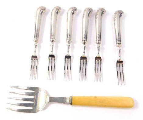 A George V silver fish serving fork, with ivory handle, Sheffield 1925, and six George V silver pistol handle fruit forks, Sheffield 1911, 7.53oz all in.