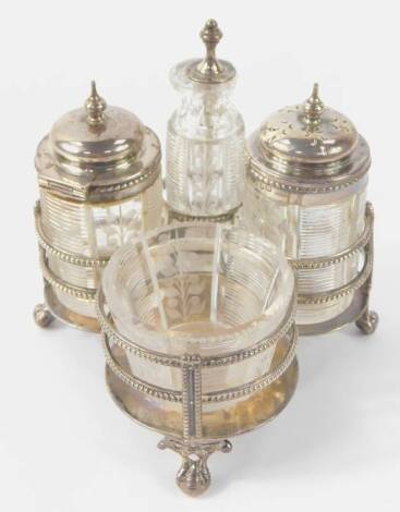 A Victorian silver galleried cruet stand, Richard Martin & Ebenezer Hall, 1873, 5.73oz, together with four matched Victorian cut glass and silver mounted cruet pieces, comprising salt, pepper, mustard pot and oil bottle, Birmingham 1872.