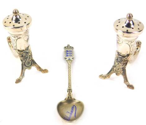 A pair of Norwegian silver pepperettes, of cornucopia form with engraved Celtic decoration, stamped Sterling, maker Theodore Olsens EFTF, together with a Danish silver and enamel Kobenhvn commemorative teaspoon, 1.48oz.