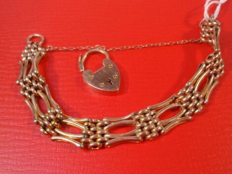 A 9ct rose gold four bar gate bracelet with padlock clasp