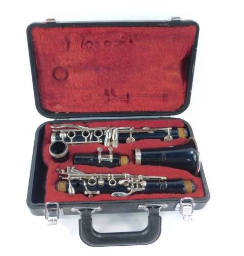 A Yamaha clarinet, cased, together with four books of sheet music.