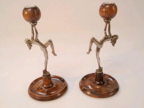 A pair of Art Deco style electroplate and turned oak candlesticks