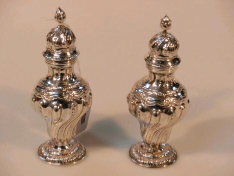 A pair of late Victorian silver pepperettes