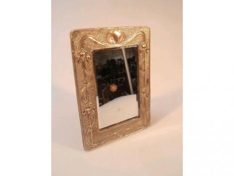 An Edwardian Art Nouveau silver easel mirror frame