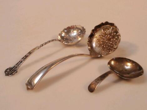 Two silver sifter spoons and a caddy spoon