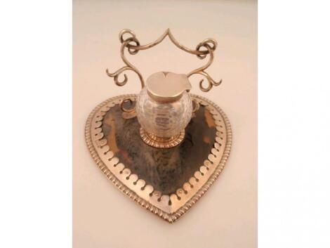 An Edwardian ladies heart shaped tortoiseshell and silver desk stand with ink well