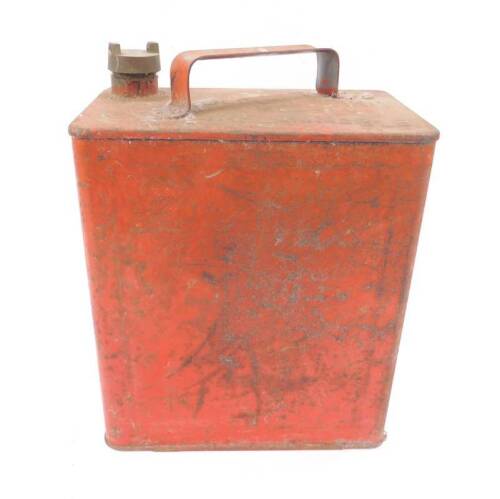 A petrol can with brass cap.