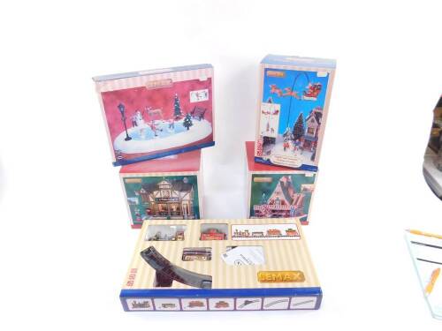 A Lemax Village Collection Santa Claus is Coming to Town, with sights and sounds, O'Reilly's Irish Gift Shop, Practice Makes Perfect (set of ten), Woodland Retreat, and Yule Tide Express, all boxed. (5)