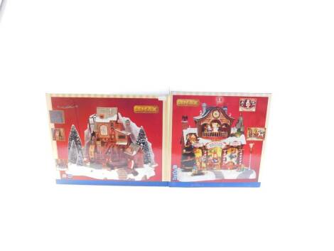 A Lemax Oak Creek Grist Mill, set of two, together with a Santa's Workshop, both boxed. (2)