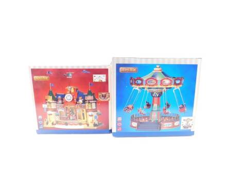 A Lemax Tim's Trains and Hobbies, set of two, together with a swing ride, both boxed. (2)