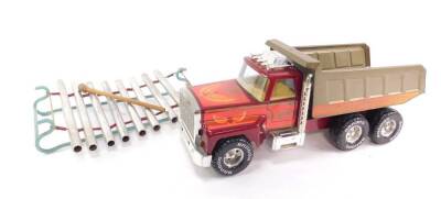 A toy xylophone, on a sledge shaped frame, together with a Nylint Corp Rockford tipper truck, (2)