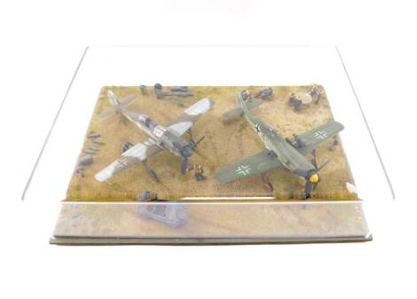 A WWII German model aeroplane tableau, containing two Focke-Wulf FW190s, armoured car and figures, perspex cased, 43.5cm x 30.5cm.