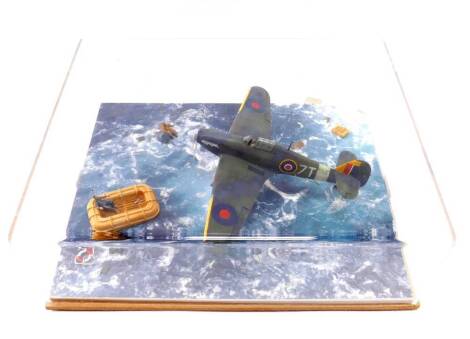 A WWII British Model Aircraft Tableau, showing a Hawker Hurricane flying over figures stranded at sea, perspex cased, 37cm x 29.5cm.