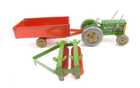 A Mettoy tin plate tractor, with a trailer and a scarifier. (3)