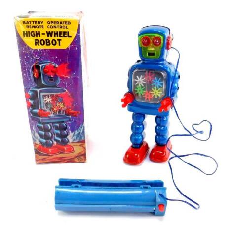 A KO Japanese battery operated remote control high-wheel robot, with transparent machine action, lighted eyes and body, telescopic aerial and walking action, no.5023, boxed.