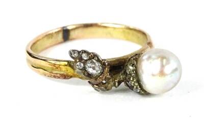 A cultured pearl and diamond acorn ring, with acorn design of single cultured pearl and the leaves and branch set with old cut tiny diamonds, on a yellow metal band, unmarked, ring size O, 2.7g all in.