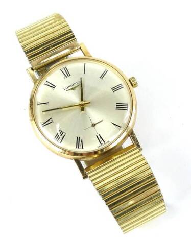 A Longines Gent's wristwatch, with inscription to back Technicolor Ltd, presented to K.J Hazelton 1946-1971, 25 years service, in yellow metal case, unmarked, on a stainless steel bracelet.