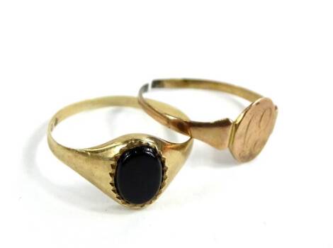 Two dress rings, to include a 9ct gold signet ring, set with black agate stone, 1.2g, and a 9ct gold signet ring, bearing the initials E.J., (AF), 0.8g.