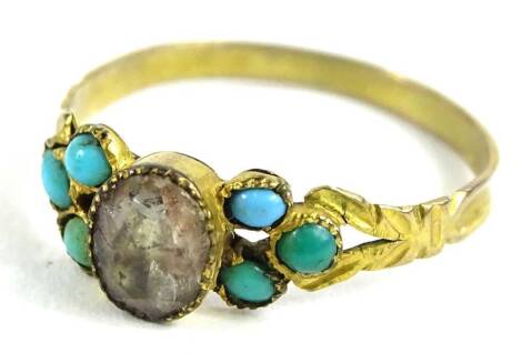 A gilt metal dress ring, set with turquoise shoulders and central white paste stone, with V shaped shoulders, ring size P, 1.1g all in.