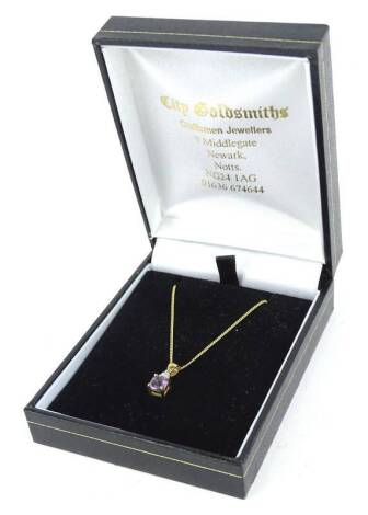 A 9ct gold pendant and chain, the pendant set with amethyst stone, and tiny diamond, on a fine link chain, 1.6g all in, boxed.