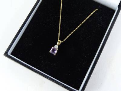 A 9ct gold pendant and chain, the pendant set with amethyst stone, and tiny diamond, on a fine link chain, 1.6g all in, boxed. - 2