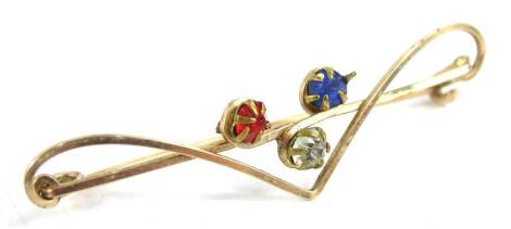 A tri-colour bar brooch, set with three paste stones, red, white and blue, on yellow metal thin frame, unmarked, 5cm W.