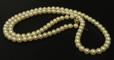 A single strand cultured pearl necklace, the pearls 6mm W, with 9ct gold clasp, 62cm L overall, in Ratners Jewellers of Value box.