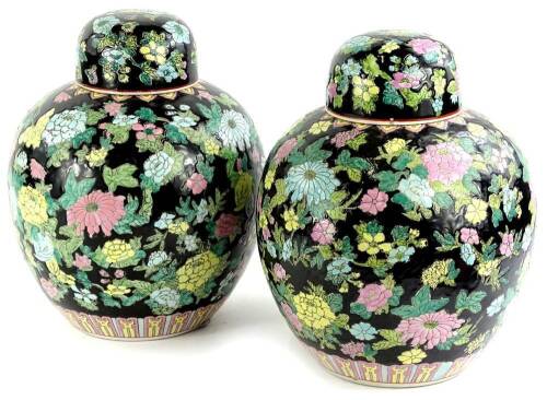 A pair of Chinese famille noire ginger jars, each decorated with brightly coloured flowers, in pink, green, turquoise etc., 30cm H.