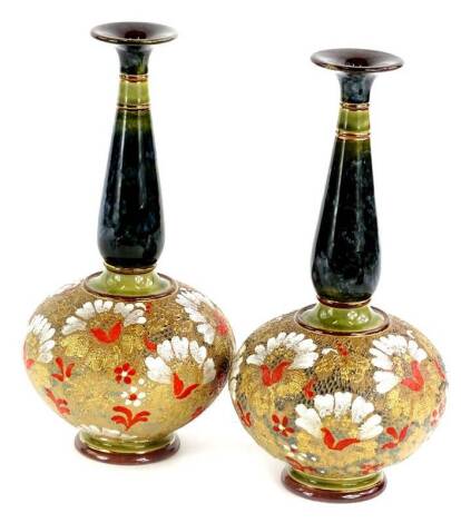 A pair of Doulton Lambeth Slaters patent bottle shaped vases, each decorated in red, gold and white with mottled green and blue necks, impressed marks to underside, 26cm H.