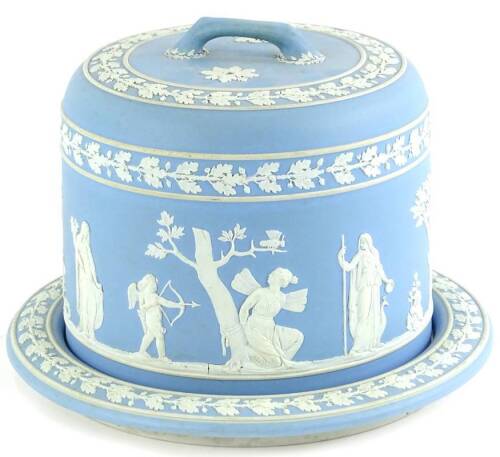 A late 19thC pale blue Jasperware cheese dome and cover, decorated with neo-classical ladies, cherubs, fairies, acorn and oak leaf bands, possibly Wedgwood, but unmarked, 27cm dia. (AF).