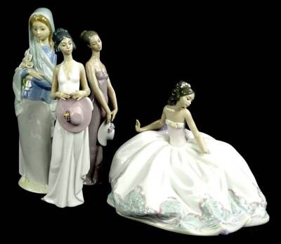 A collection of four Lladro porcelain figures, to include a lady with a large evening of wedding dress, two figures carrying a hat and a figure carrying lilies.