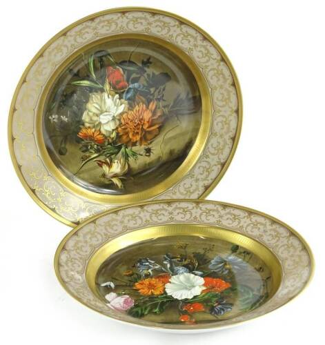 A pair of Kaiser flower bouquet porcelain plaques, each decorated with an old master scene after De Heem, 32cm dia.