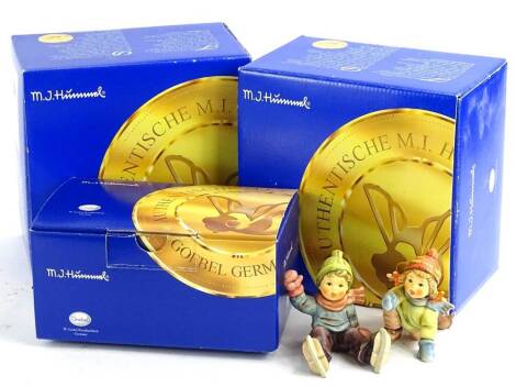 A collection of Hummel figures, to include two boys on skates, each in original packaging.