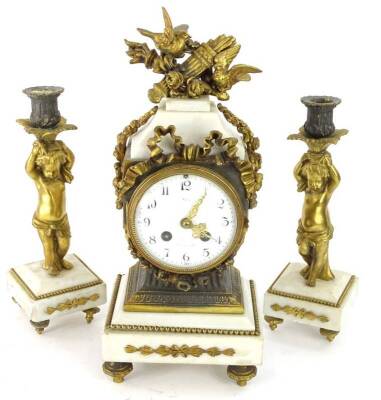 A late 19thC French gilt metal clock garniture, the white enamel dial with Arabic numerals, case decorated with quiver torch, birds etc., on a white marble plinth, flanked by a pair of figural candlesticks, on tapering feet, 36cm H.