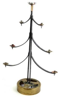 An engineer made tree shaped seven branch candle stand, with copper sconces, wrought iron arms and a circular recycled brass base, 59cm H.