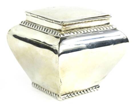 A silver sugar box or tea caddy, of square tapering form with gadrooned bands and a hinged lid, marks indistinct, 3½oz.