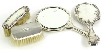 A collection of dressing table items, to include two silver mounted hand mirrors and two brushes, various dates.