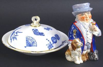 A Royal Worcester aesthetic movement muffin dish and cover, decorated with fans, scrolls etc., in the oriental style, printed mark in blue to underside and a Wedgwood & Co character jug Ye Olde Village in Squire (2).