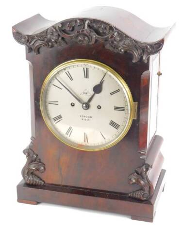 A late 19thC Dent mantel clock, in figured mahogany case, carved with flowers, scrolls etc., the silvered dial stamped Dent London 61914 on a plinth with block feet, 45cm H, 33cm W.