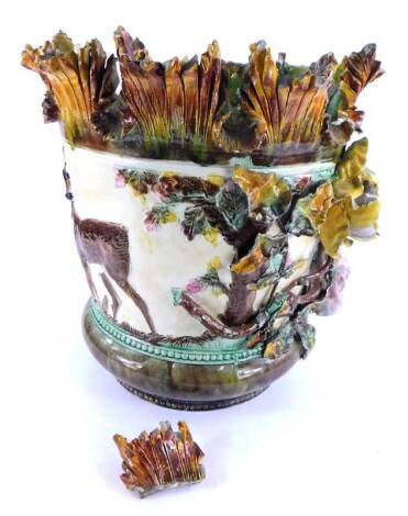 A 19thC Minton type Majolica jardiniere, decorated in relief with deer, flowers, leaves etc., (AF), 40cm H.