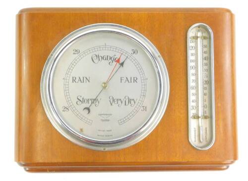 A Federal brand aneroid barometer, with silvered dial and thermometer in a walnut case, 34cm W.