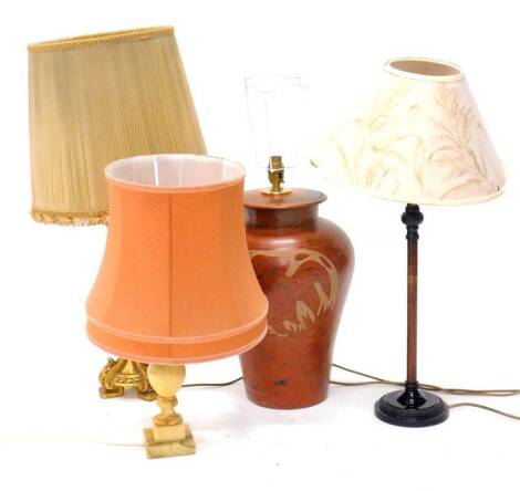 A collection of table lamps, to include a marble example, a bronzed base metal table lamp, a gilt table lamp, and an Eastern lamp with engraved decoration of fish. (4) Provenance: The property of Joan Stephenson, Kirkwood, North Church Walk, Newark, Notti