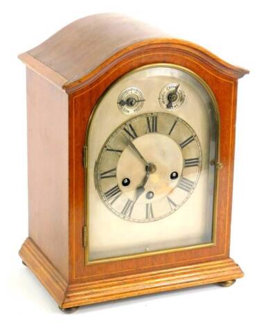 An early 20thC mahogany mantel clock, the silvered dial with subsidiary slow fast and chime silent dials, on bun feet, 32cm H.