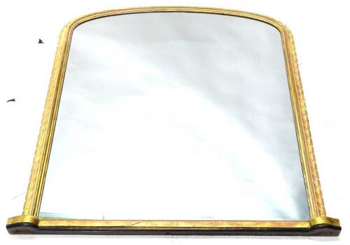 A Victorian gilt over mantel mirror, with arched plate, the frame with a gadrooned border, 132cm H, 121cm W.